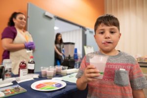 Child drinking a smoothies at food bank health fair