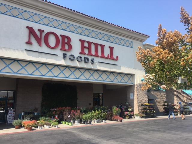 Front view of exterior of Nob Hill Foods grocery store in Hollister, CA